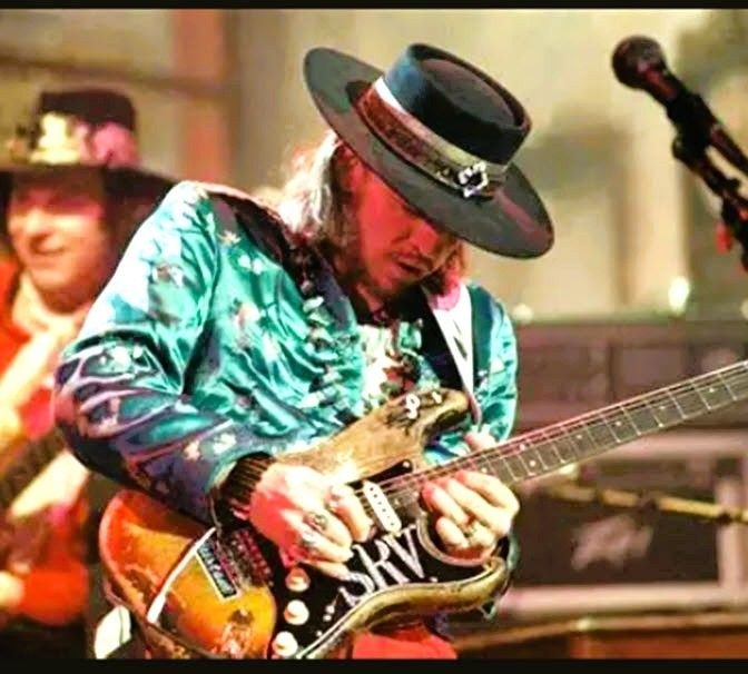 Stevie Ray Vaughan — live on stage playing guitar